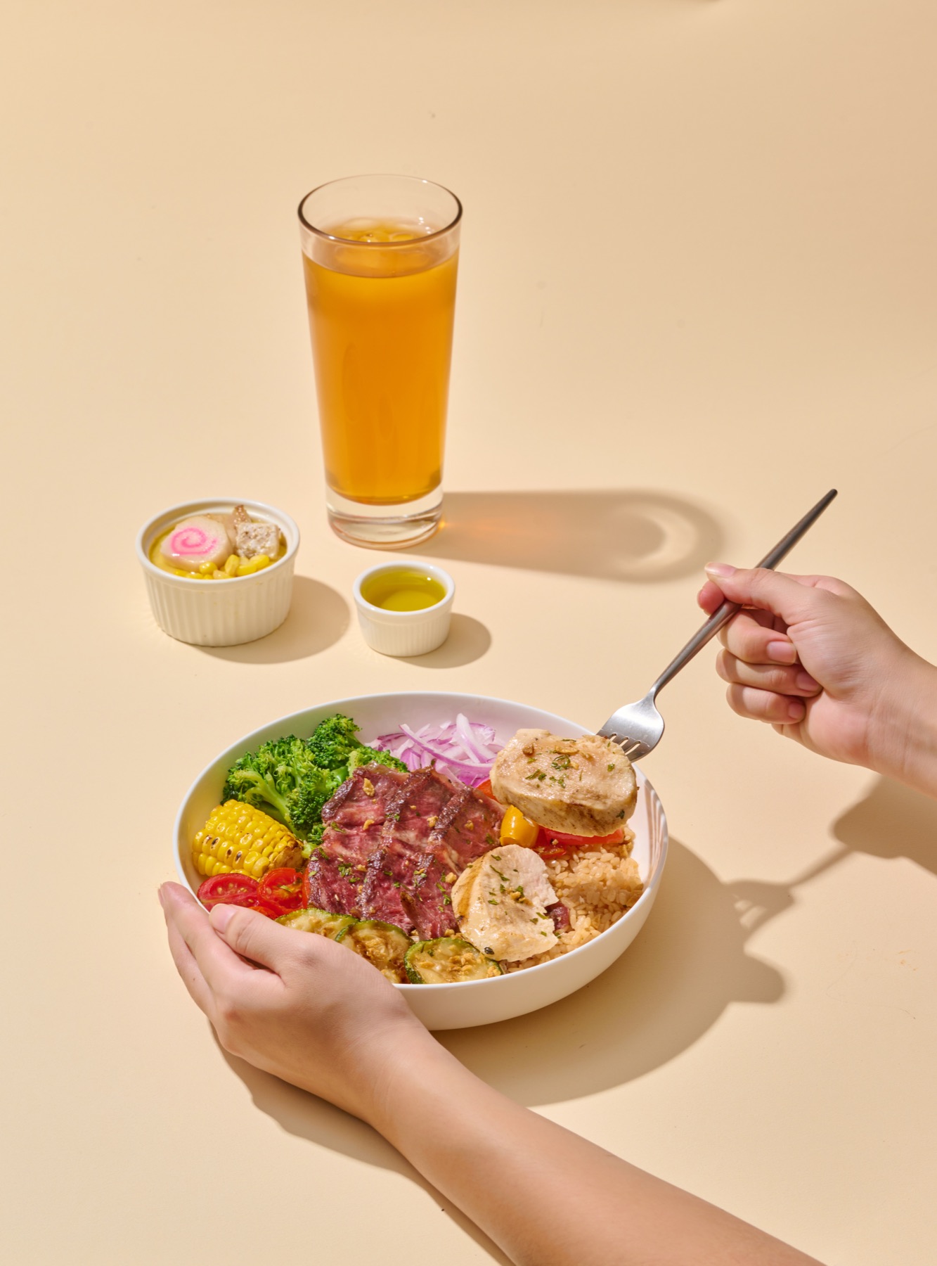A guest holding an OKAO Bowl and enjoying a hot meal